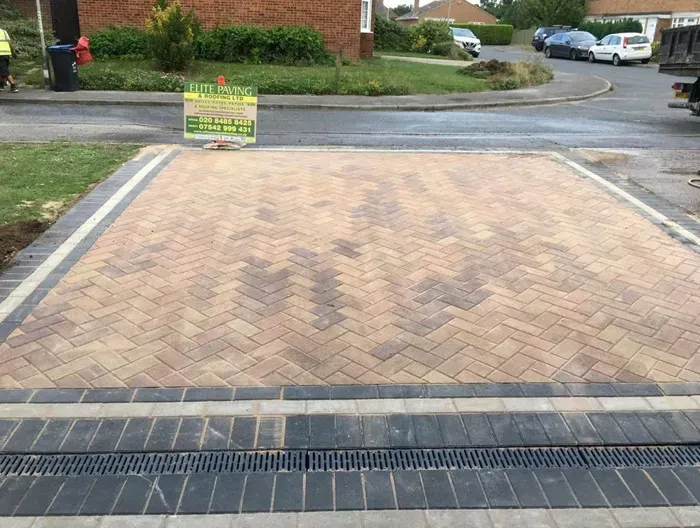 Newly installed block-paved driveway with a herringbone pattern and drainage by Elite Paving and Roofing LTD in Canterbury.